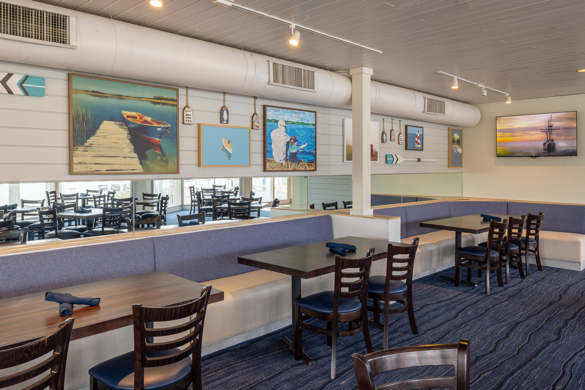 Booth seating with nautical artwork