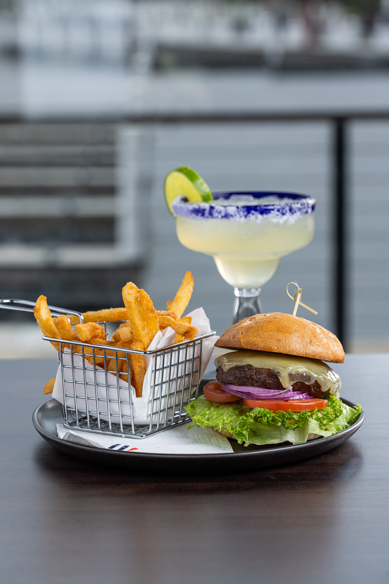 Harbor burger with fries and a margarita on the deck