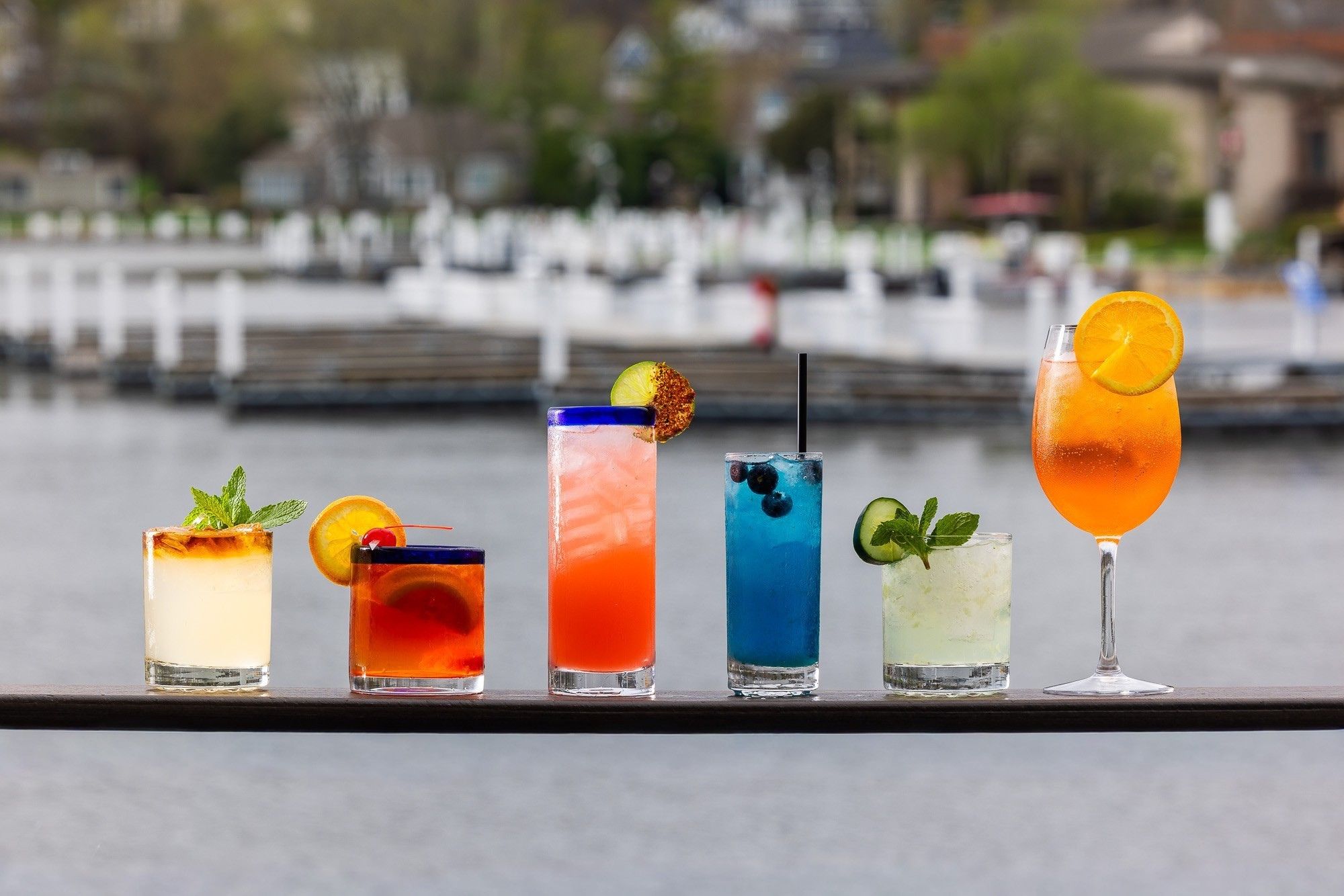 Lineup of signature cocktails overlooking the harbor